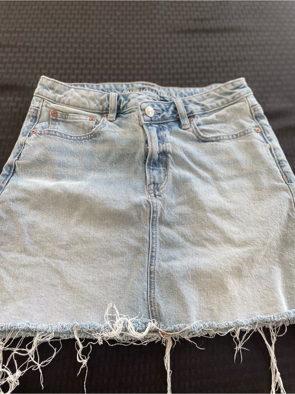American Eagle Outfitters Light Wash Denim Mini Skirt with Frayed Hem